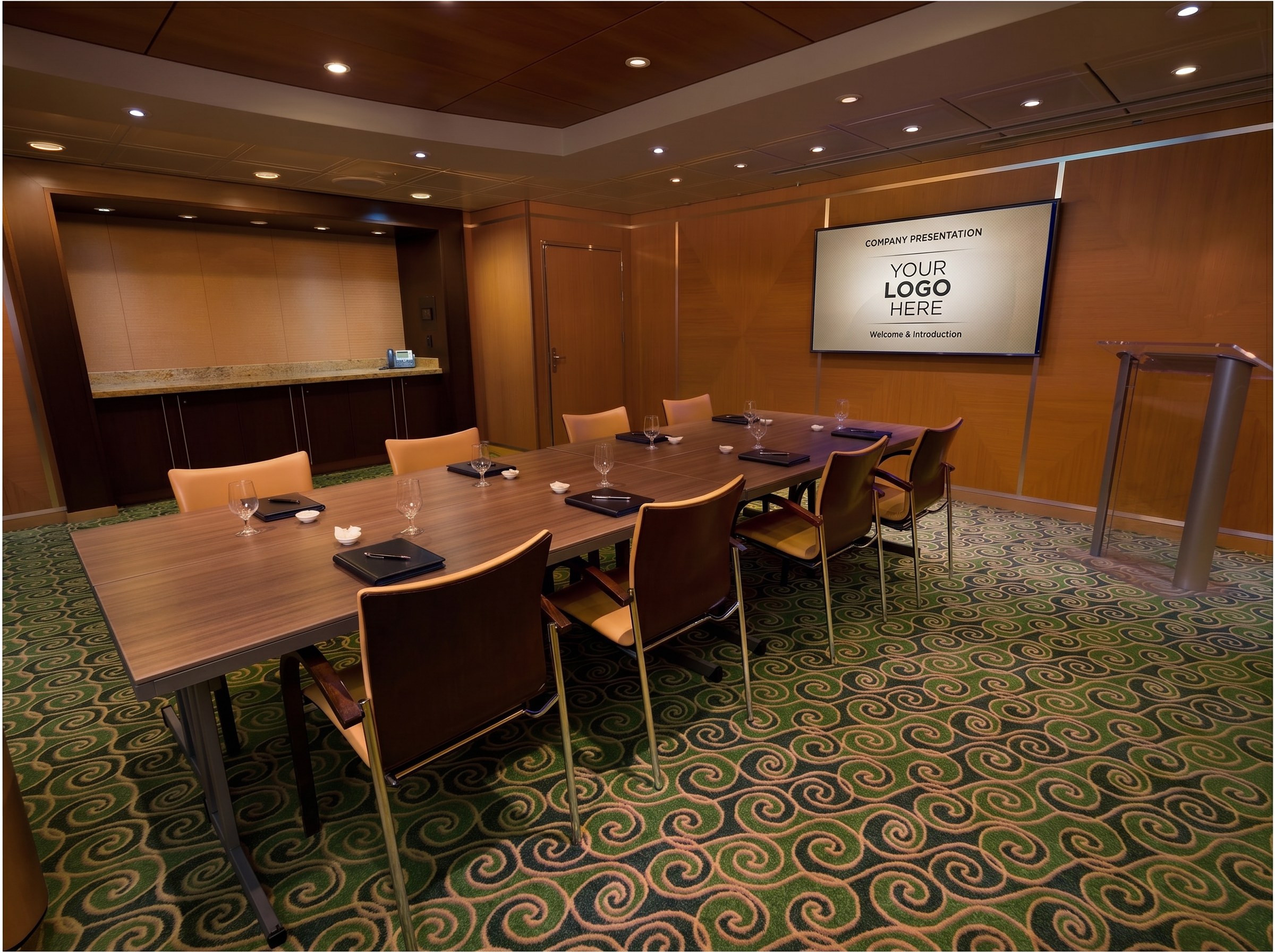 Conference room configured Boardroom-style — long table with chairs around it and place settings